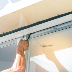 hand with screwdriver, tighten the screw stopper window.